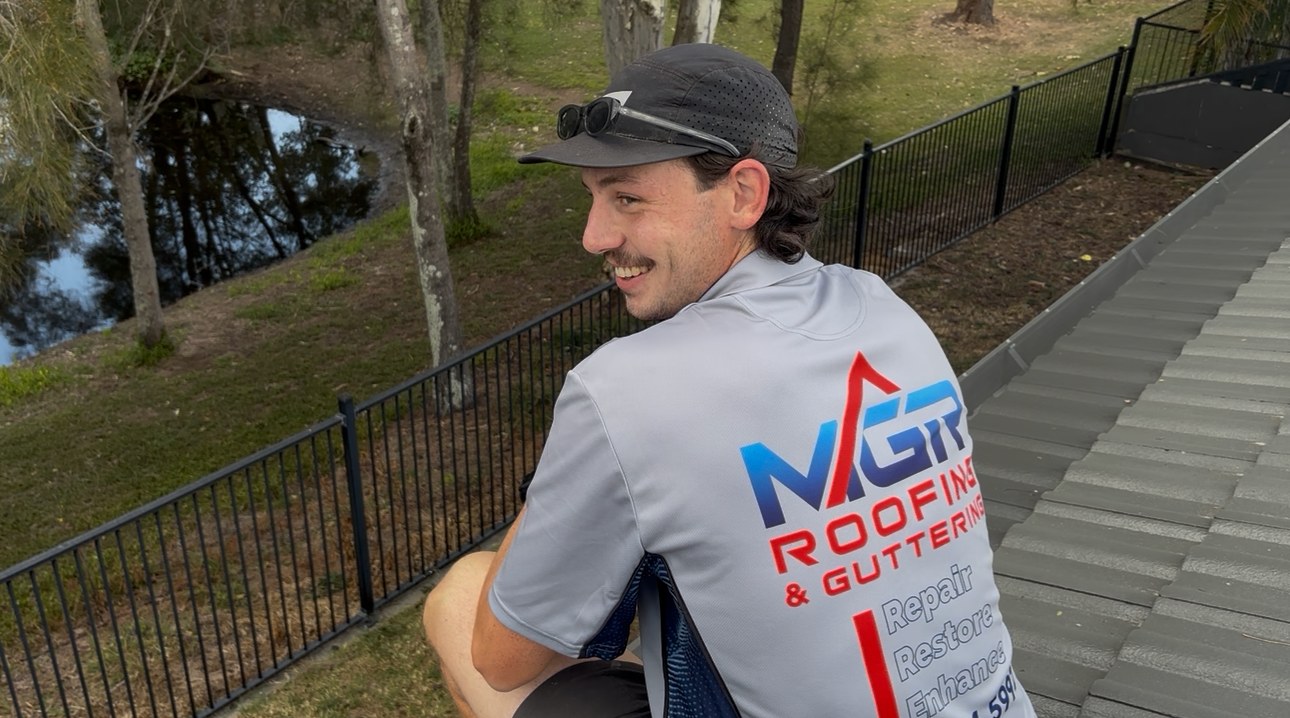 MGR team member installing gutter guard on a tiled roof
