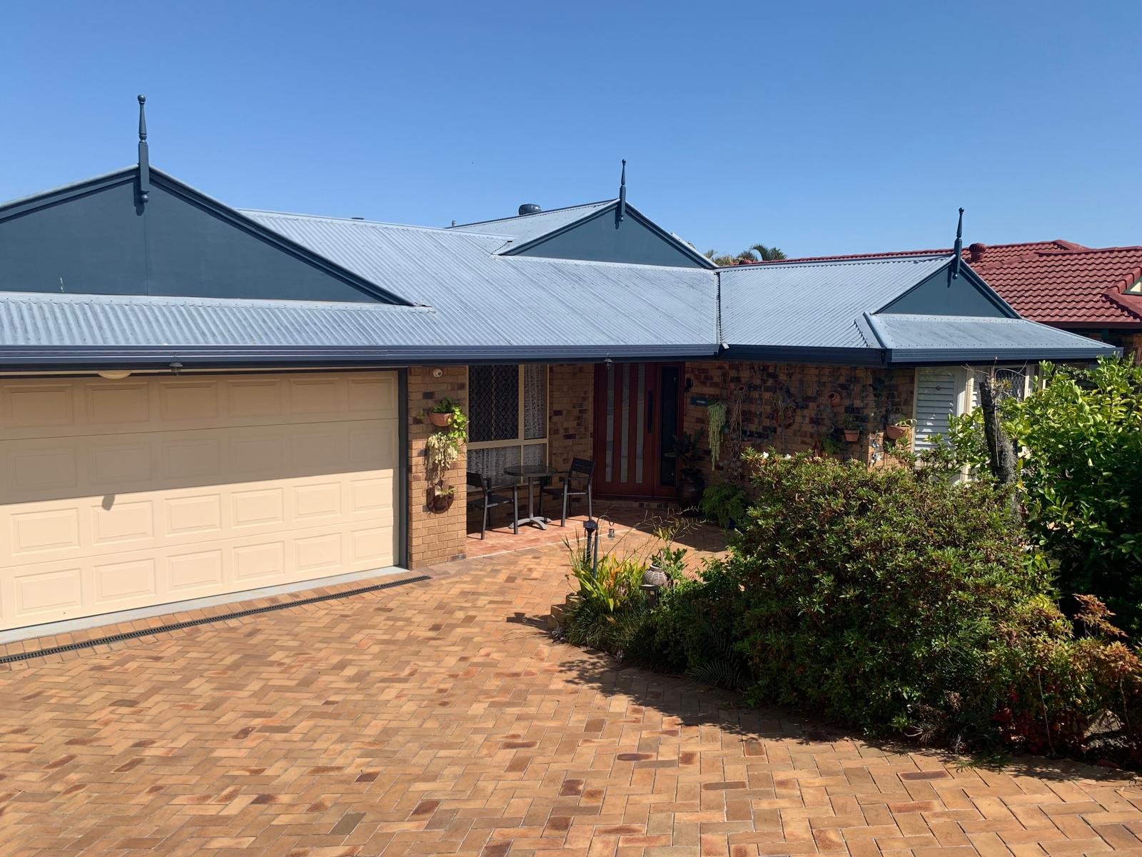 Replacement metal roof and gutters on an established home